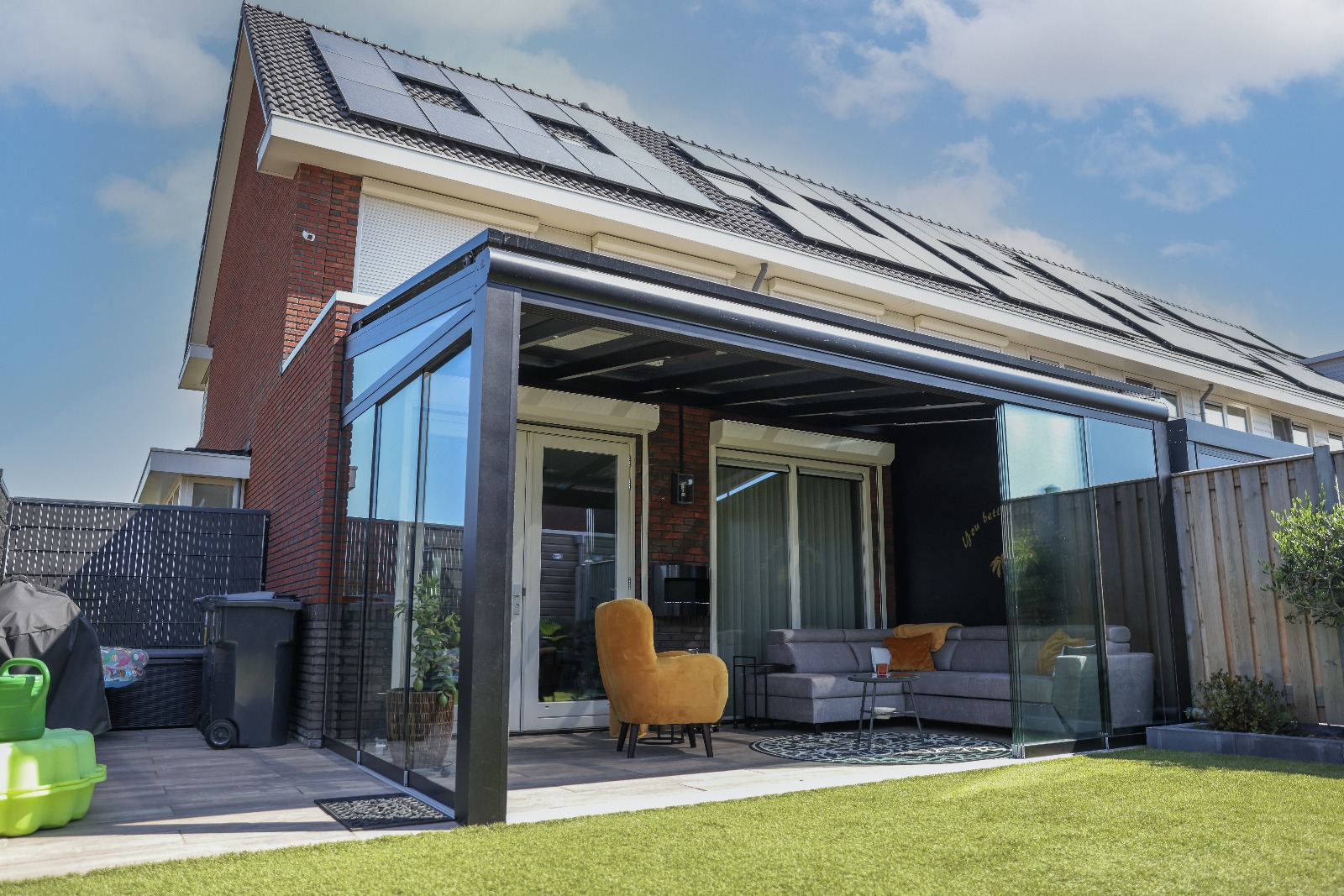 The Provence glass-roofed veranda with sliding wall and orange chair