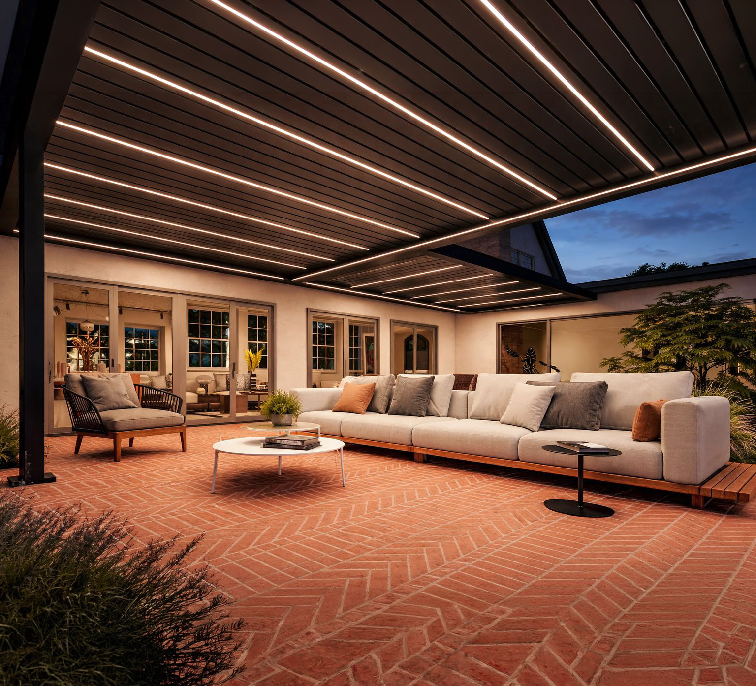 Brisa pergola at dusk with integrated LED lighting over a lounge terrace